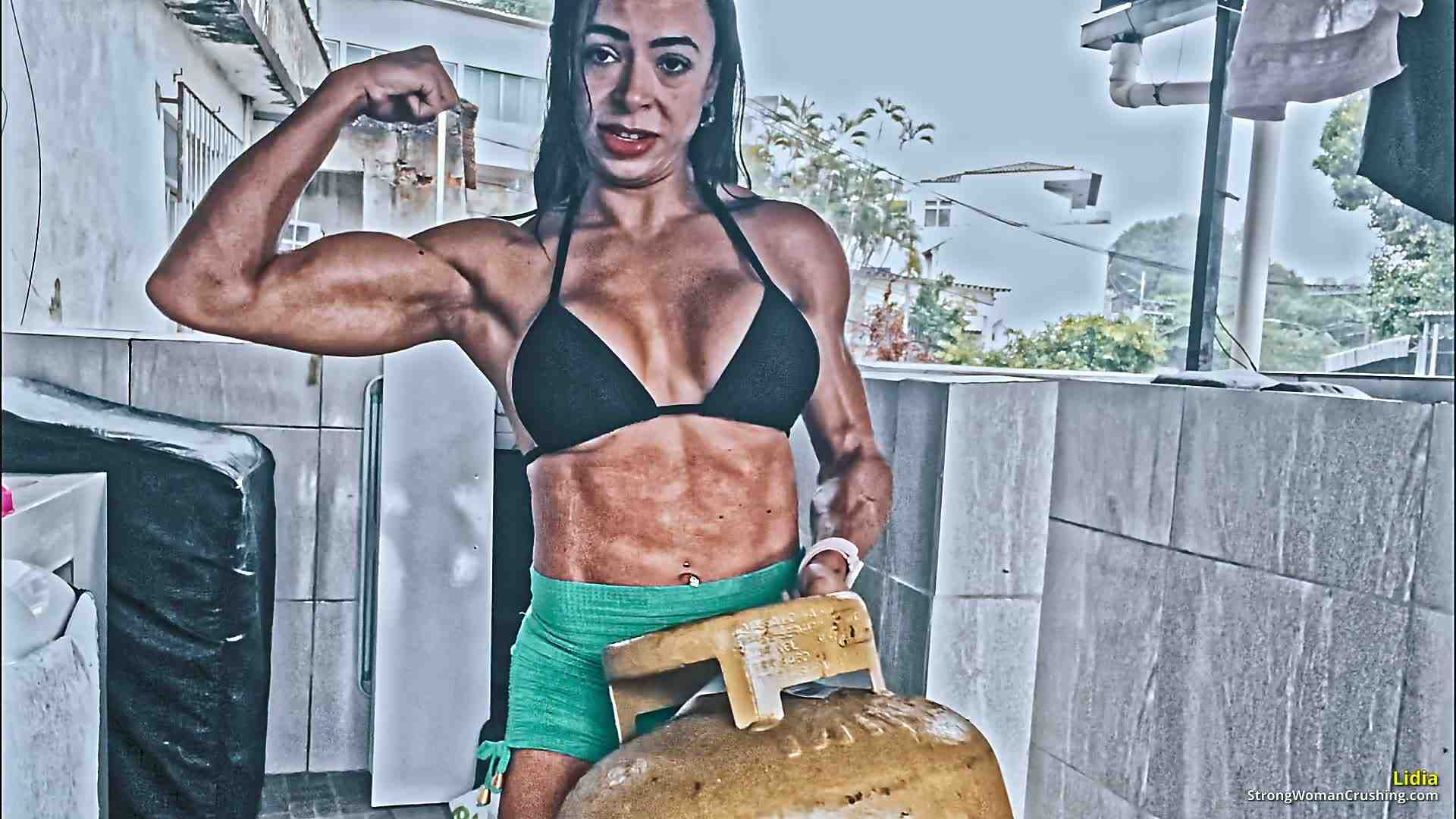 Lidia pumps her muscles with a gas cylinder