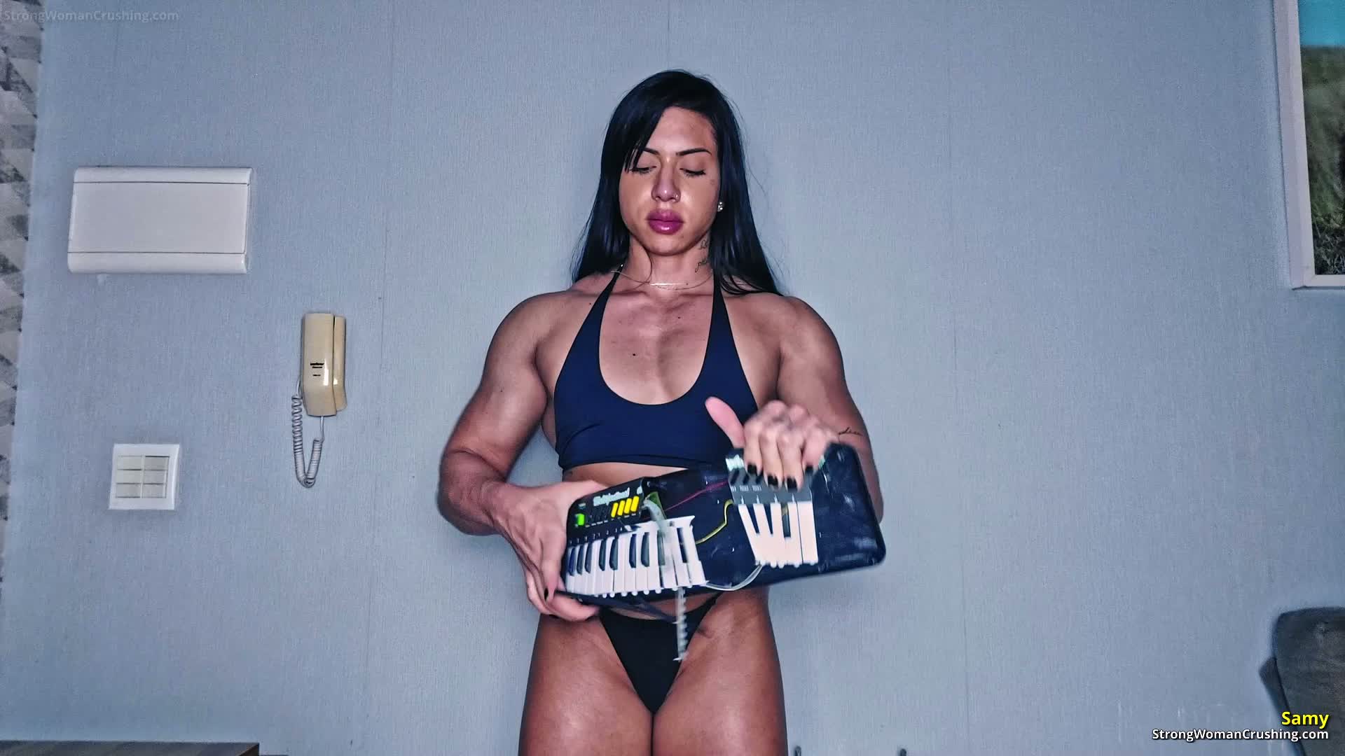 Samy crushes a musical keyboard with her bare hands